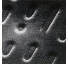Microscope picture of pits in an optical disc.