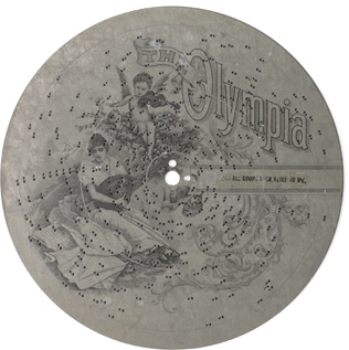 Steel disc with punched out pins and attractive illustration printed on face for the Olympia music box