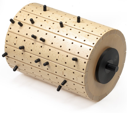 Large polished wooden cylinder with plastic pegs in holes for Gloggomobil mechanical glockenspiel