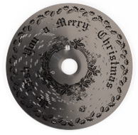 Small shiny metal music box disc with tabs, with lithographed Christmas text and decorations
