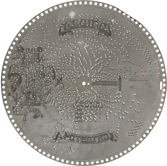 Large zinc  disc with punched out pins and Regina branding printed on face for Regina Music Box