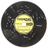 Small polished steel disc with punched out pins and paper label for Thorens music box