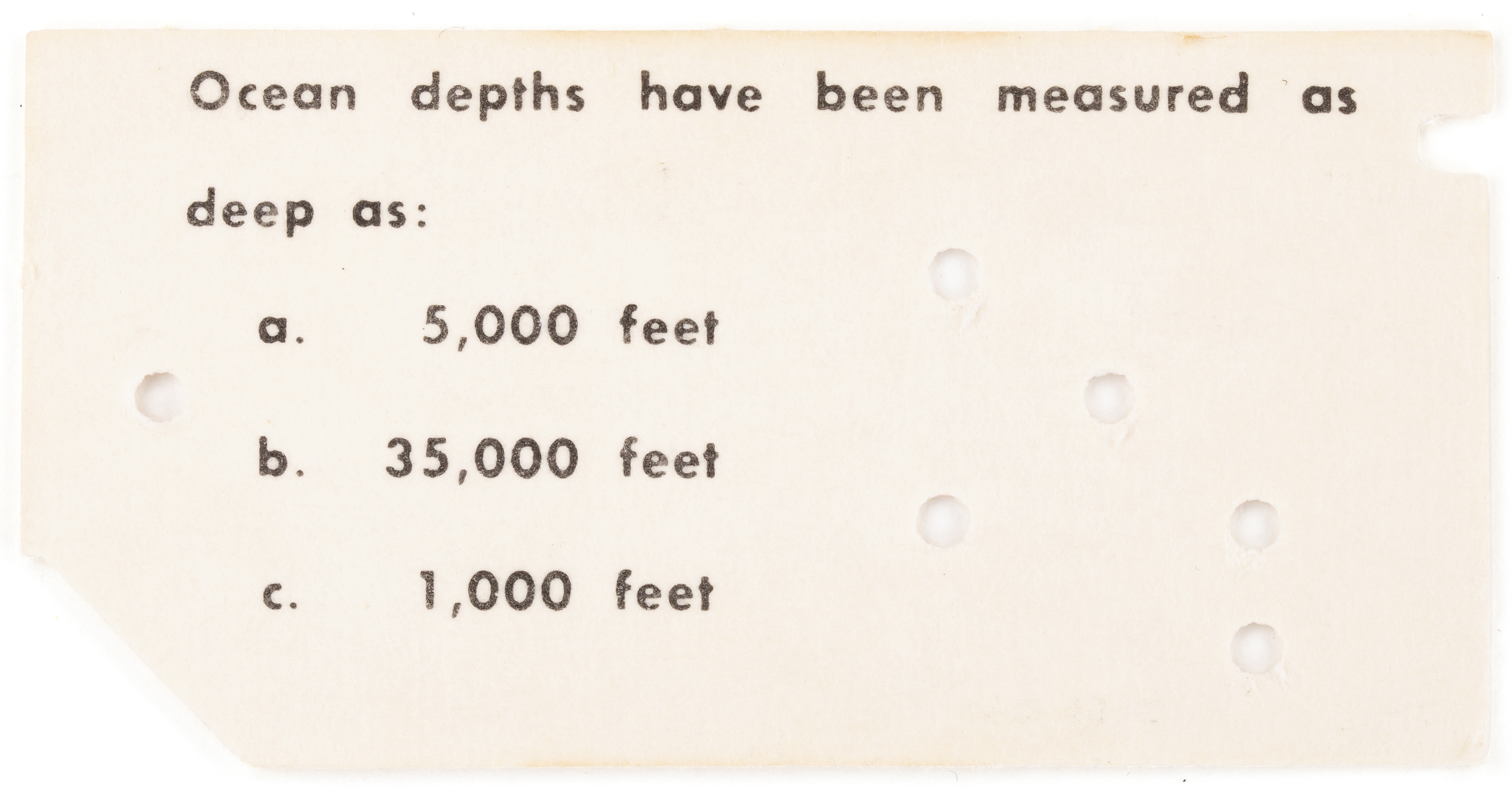 A tiny edge-nochted card shaped like a punch card with punched holes and a trivia question with 3 possible answers.
